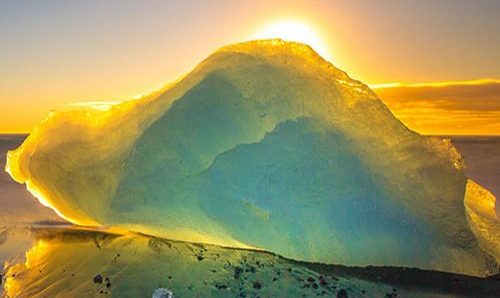 The Enchanting Seascape: Glowing Transparent Stones in the Embrace of Sunset